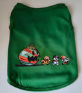 Green dog shirt with a giant menacing Christmas ornament chasing a gingerbread man, snowman, and elf graphic