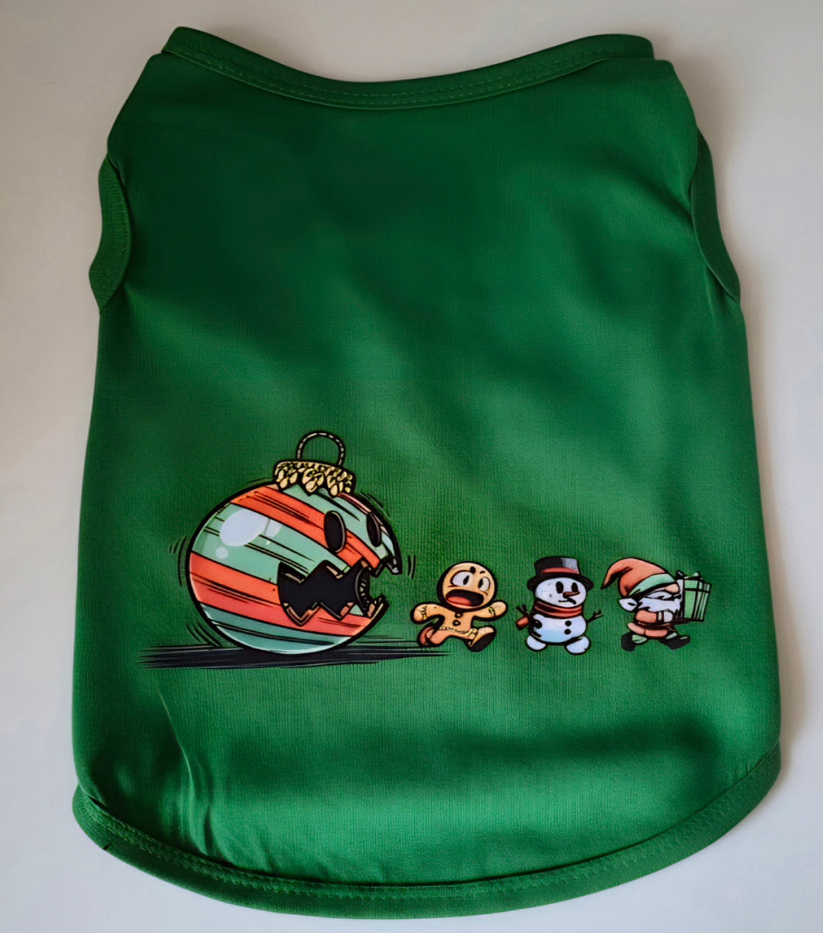 Green dog shirt with a giant menacing Christmas ornament chasing a gingerbread man, snowman, and elf graphic
