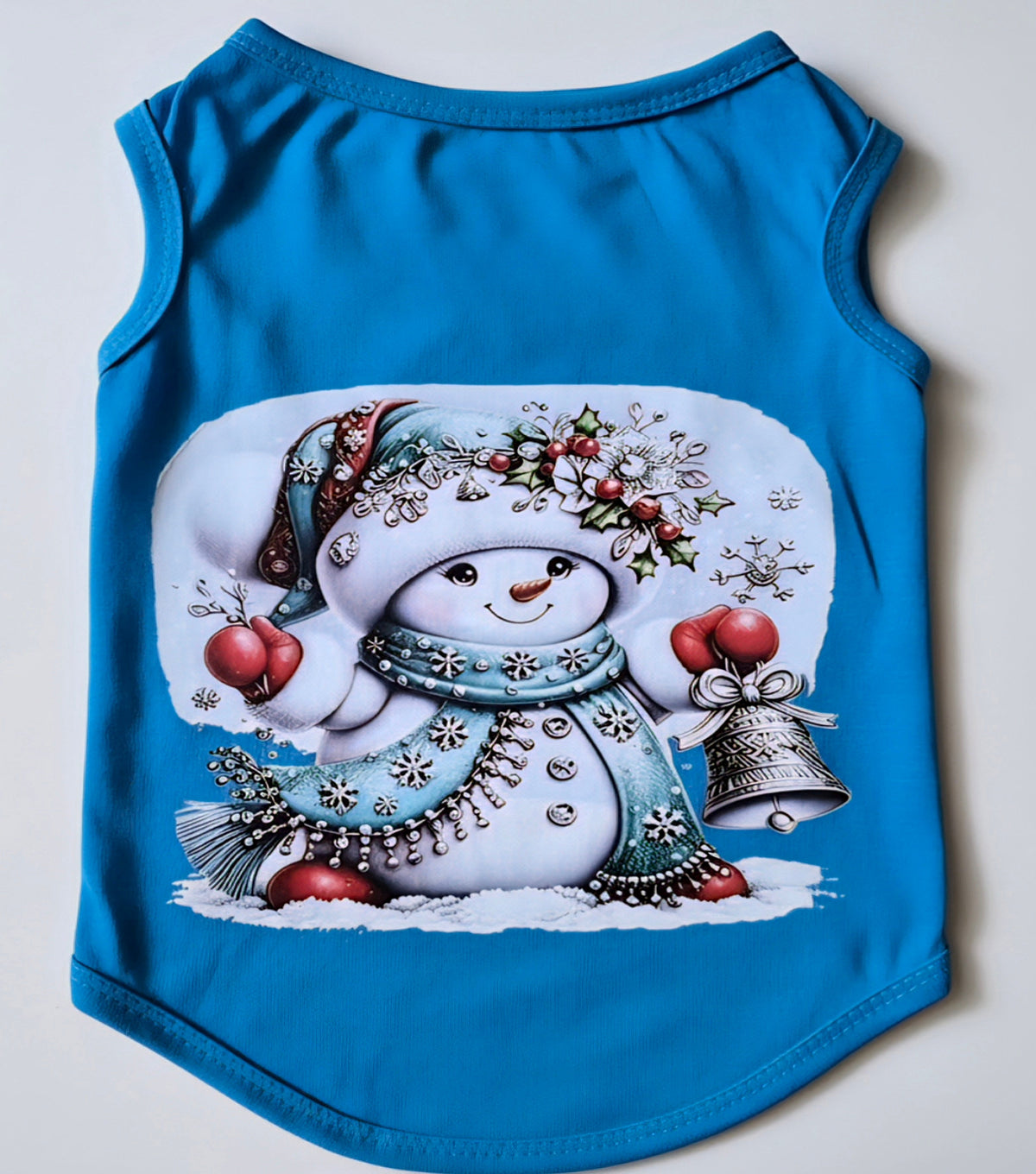 Blue dog shirt with festive snowman holding a jingle bell holiday graphic