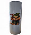 Light-colored tumbler featuring a brown puppy in Christmas greenery with ornaments, a Santa hat, and a gold star