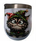 Wide-eyed cat wearing a candy-cane hat and evergreen garland on a white holiday wine tumbler